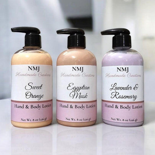 Displayed against a bright bathroom setting, these NMJ Handmade Creations hand and body lotions come in three appealing scents: Sweet Orange, Egyptian Musk, and Lavender & Rosemary. Each bottle features a clean, white label with elegant pink accents that highlight the distinct fragrance, creating a soothing visual appeal