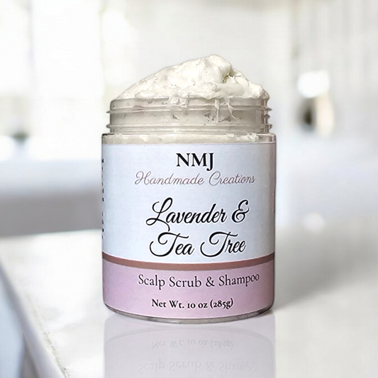 A jar of NMJ Handmade Creations' Lavender & Tea Tree Scalp Scrub & Shampoo, showcasing a lush white texture, set in a tranquil bathroom setting