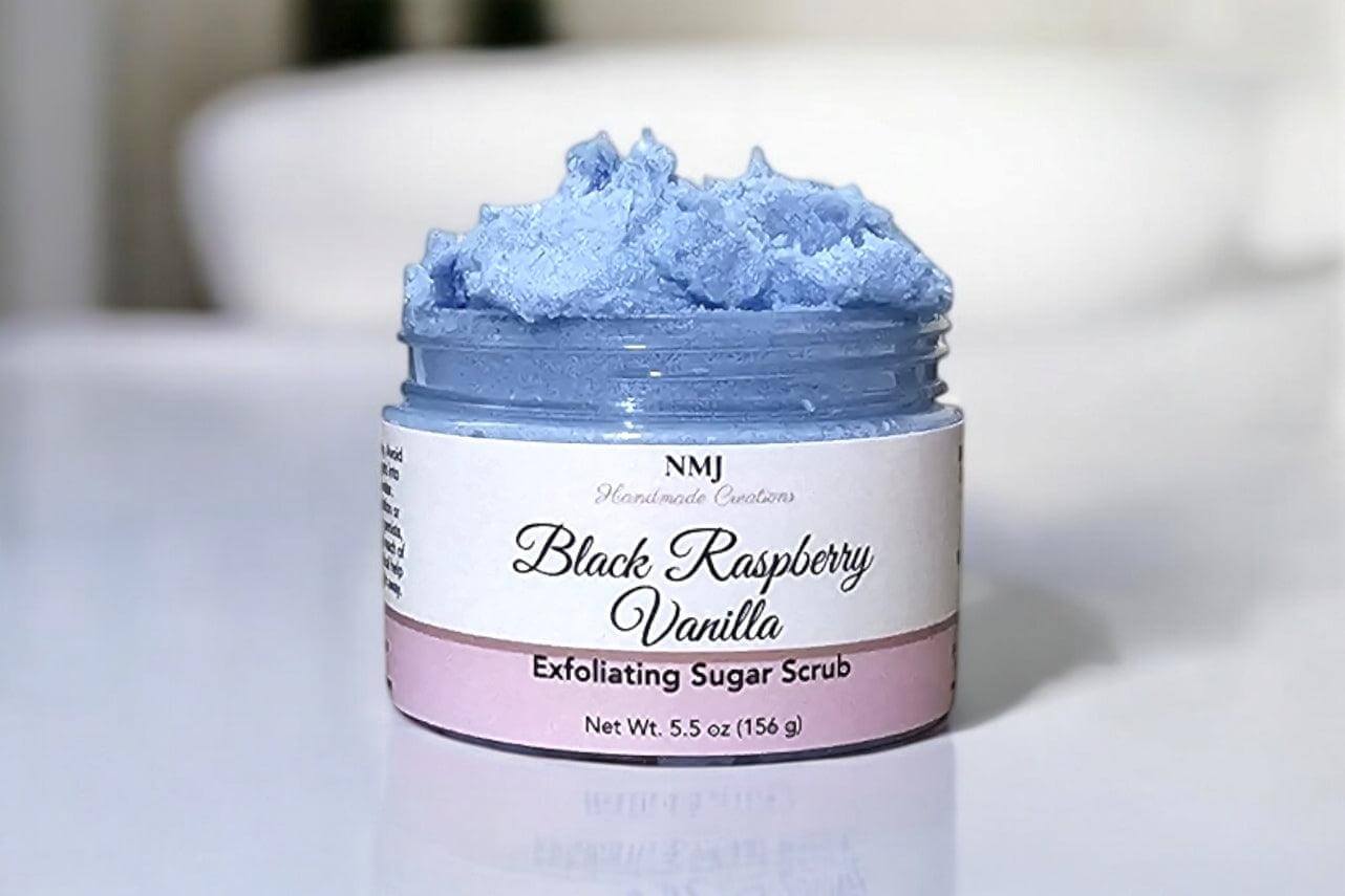 Exfoliating Sugar Scrub in Black Raspberry Vanilla scent by NMJ, 5.5 oz jar showcasing smooth blue texture.