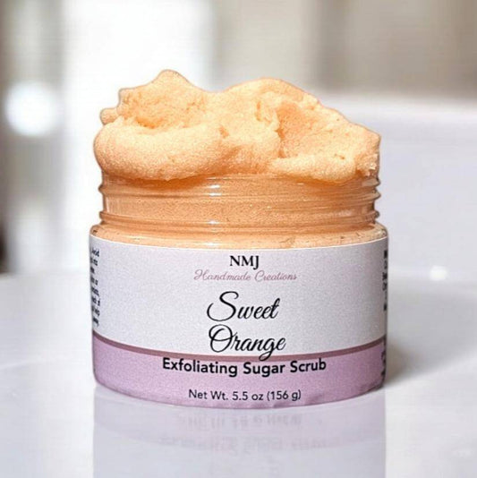 Exfoliating Sugar Scrub with Sweet Orange scent in 5.5 oz jar by NMJ, offering radiant skin and refreshing exfoliation experience.