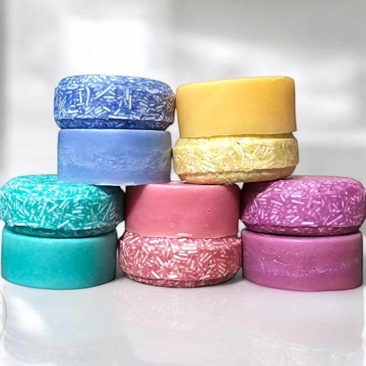 Colorful shampoo and conditioner bar set with moisturizing oils, eco-friendly and plastic-free packaging, perfect for sustainable hair care.